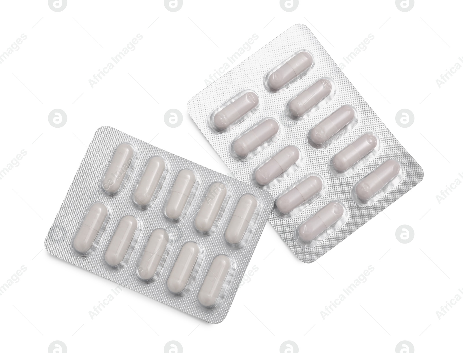 Photo of Antibiotic pills in blisters isolated on white, top view