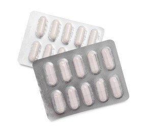 Photo of Antibiotic pills in blisters isolated on white, top view