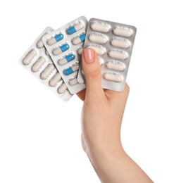 Photo of Woman with antibiotic pills on white background, closeup