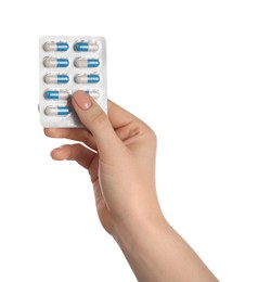 Woman with antibiotic pills on white background, closeup