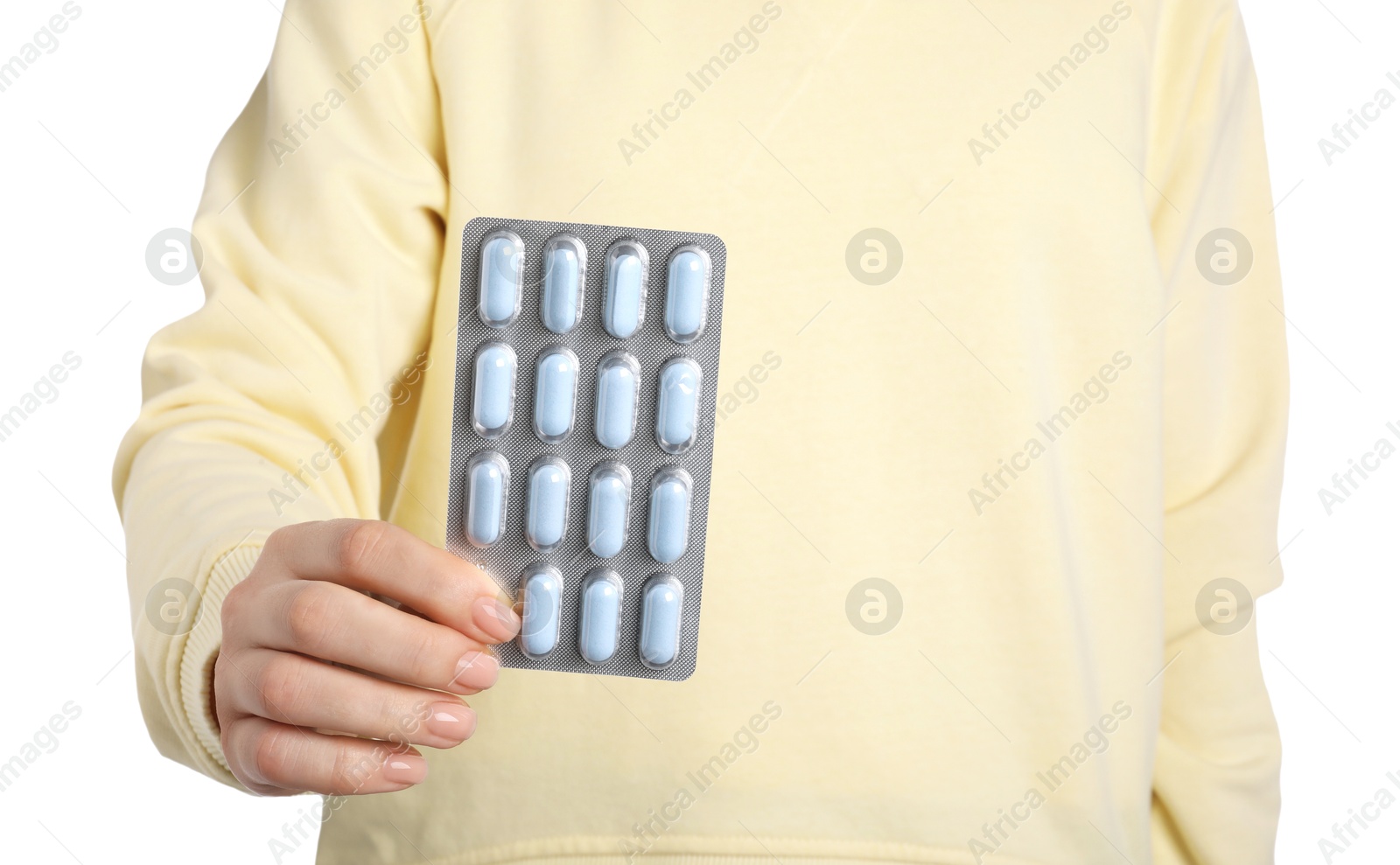 Photo of Woman holding blister with antibiotic pills on white background, closeup