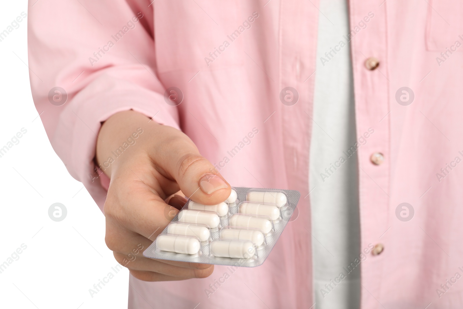 Photo of Woman holding blister with antibiotic pills on white background, closeup