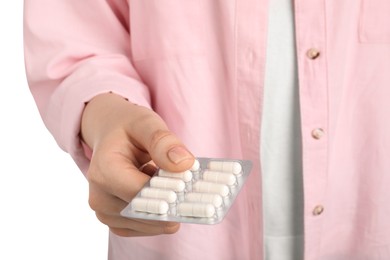 Photo of Woman holding blister with antibiotic pills on white background, closeup