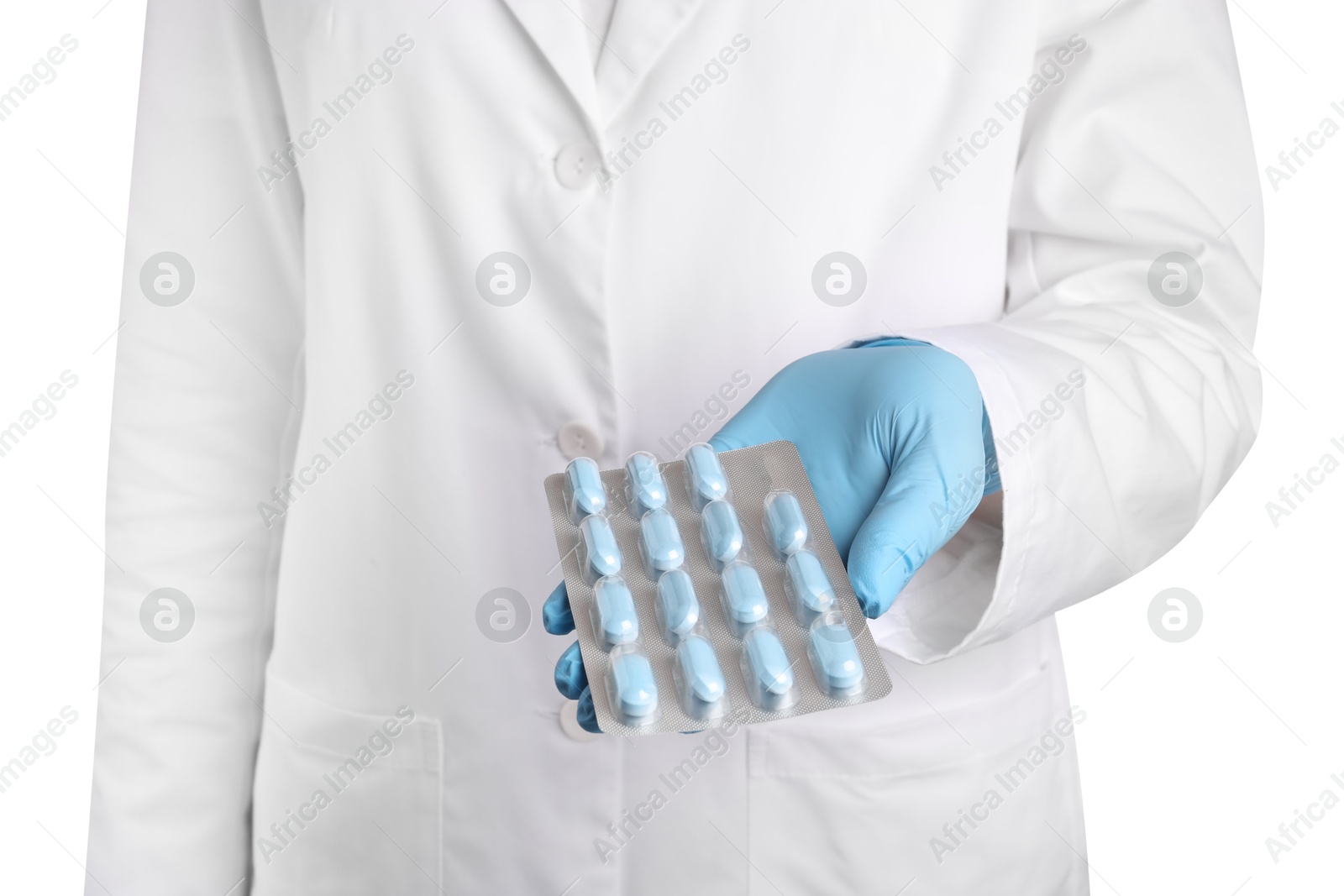 Photo of Doctor holding blister with antibiotic pills on white background, closeup