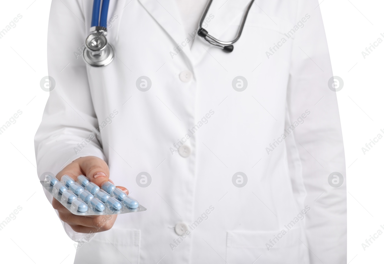 Photo of Doctor holding blister with antibiotic pills on white background, closeup