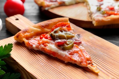 Photo of Wooden board with delicious pizza Diablo on table, closeup