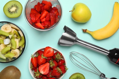 Photo of Hand blender kit, fresh fruits and strawberries on turquoise background, flat lay