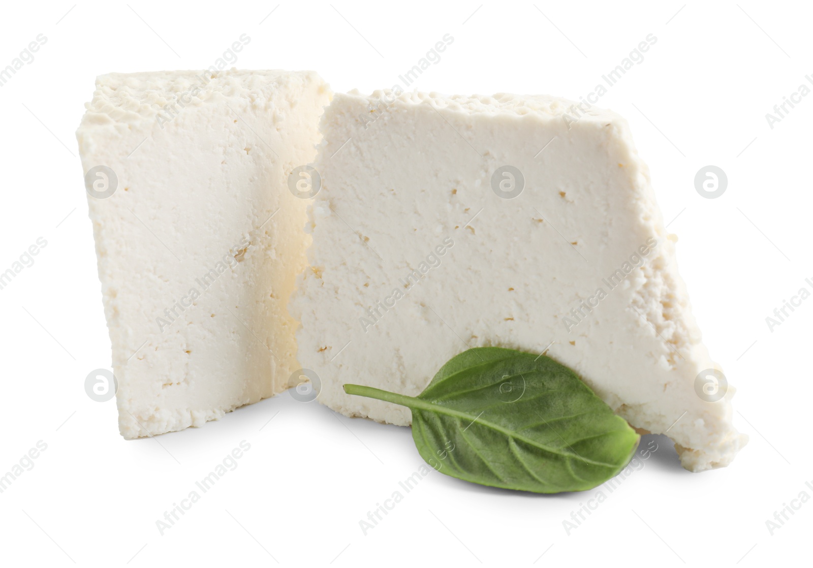 Photo of Tasty ricotta (cream cheese) and basil isolated on white