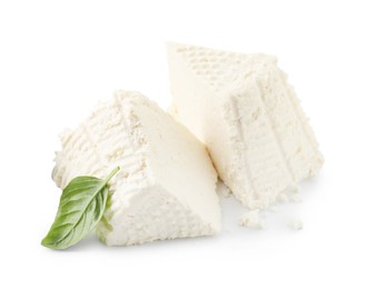 Photo of Tasty ricotta (cream cheese) and basil isolated on white