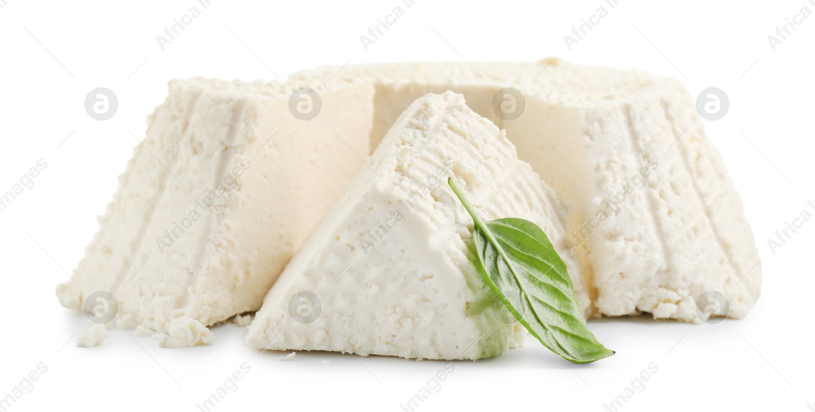 Photo of Tasty ricotta (cream cheese) and basil isolated on white