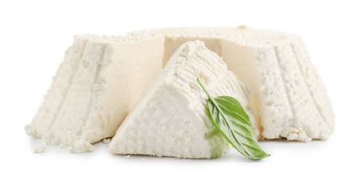 Photo of Tasty ricotta (cream cheese) and basil isolated on white