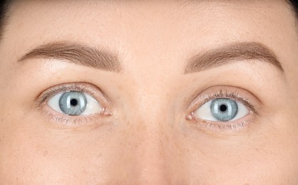 Photo of Woman with beautiful blue eyes, closeup view