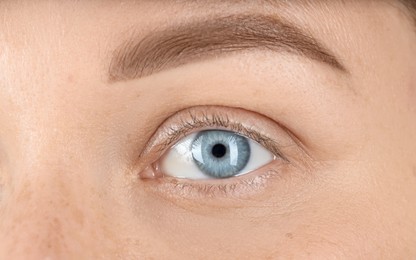 Woman with beautiful blue eyes, macro photo