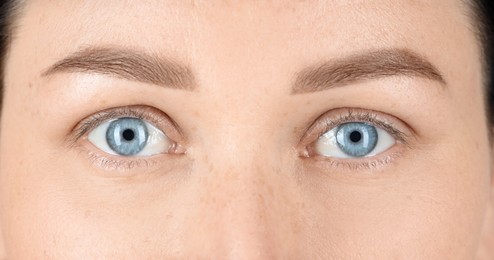 Photo of Woman with beautiful blue eyes, closeup view