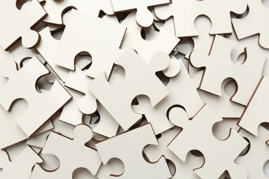 Pile of white puzzle pieces as background, top view