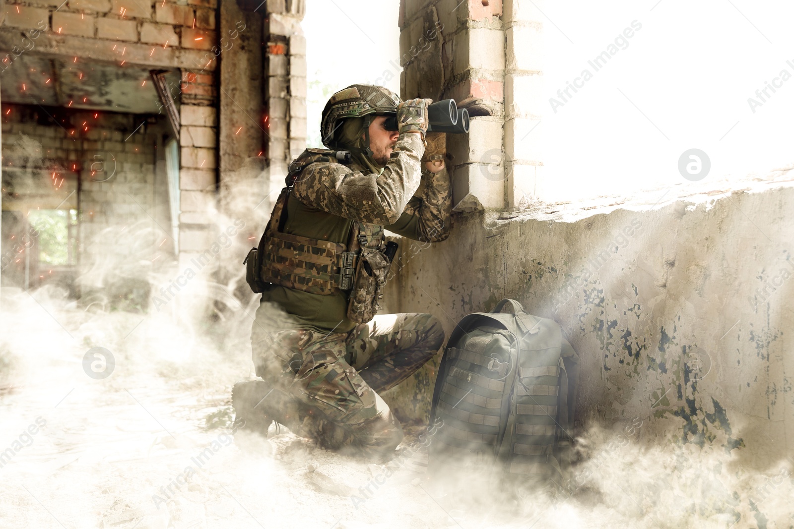 Image of Soldier using binoculars in building during military operation