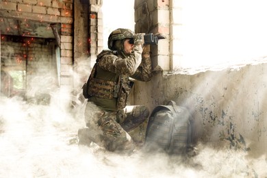 Image of Soldier using binoculars in building during military operation