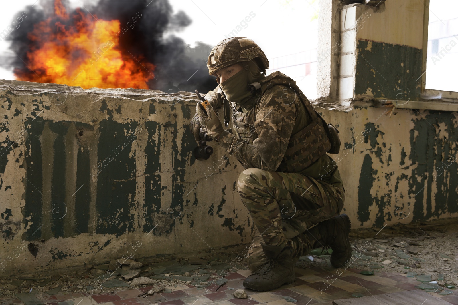 Image of Soldier using radio in destroyed building during military operation