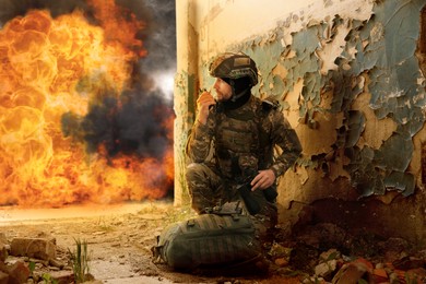 Image of Soldier using radio in destroyed building during military operation