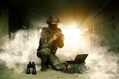Image of Soldier with drone controller inside building during military operation