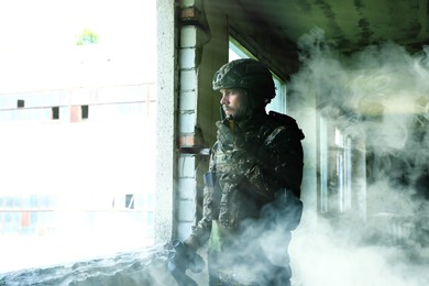 Image of Soldier using radio in building during military operation