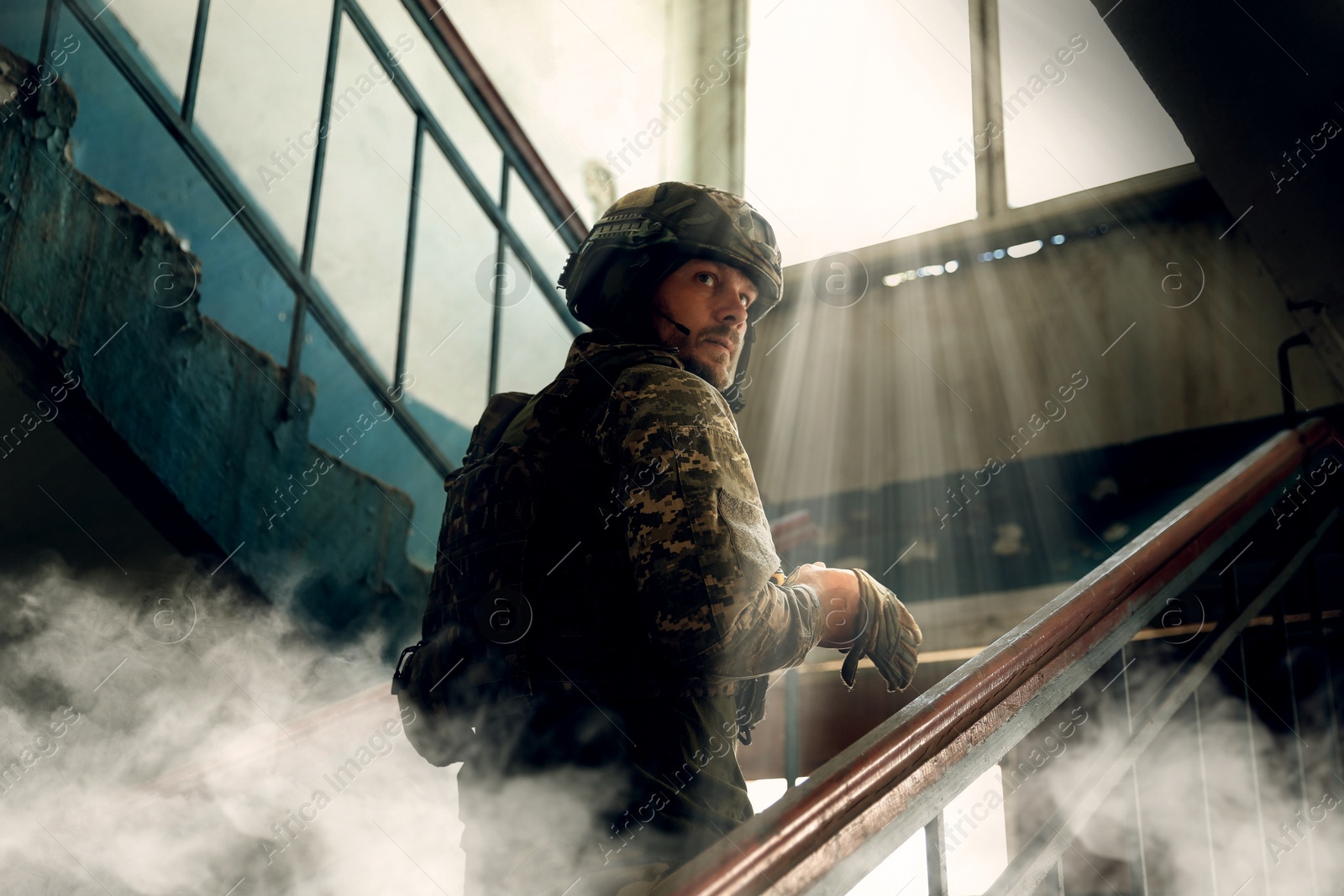 Image of Soldier going upstairs inside building during military operation