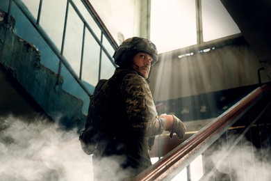 Image of Soldier going upstairs inside building during military operation