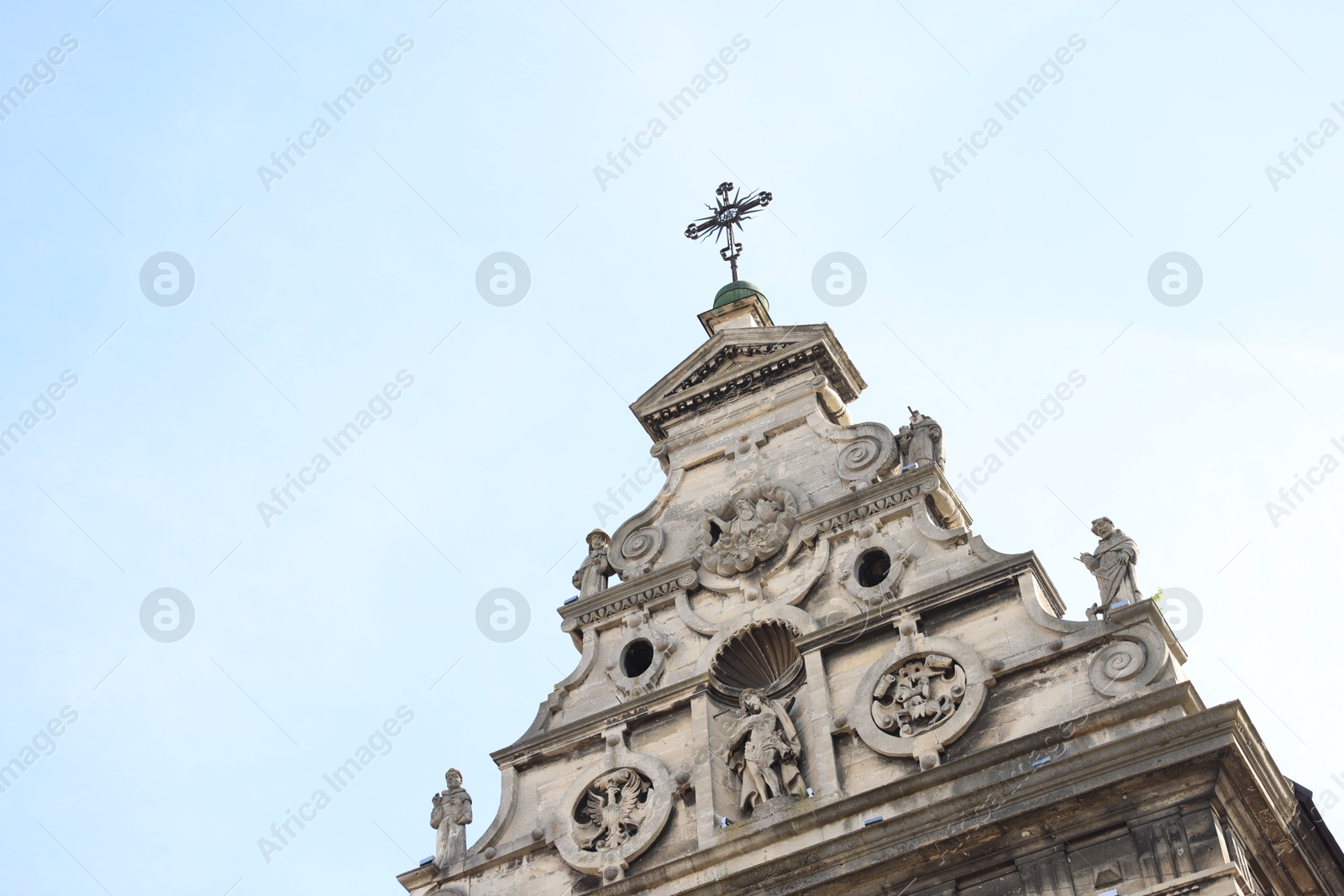 Photo of Beautiful old cathedral against blue sky, low angle view. Space for text