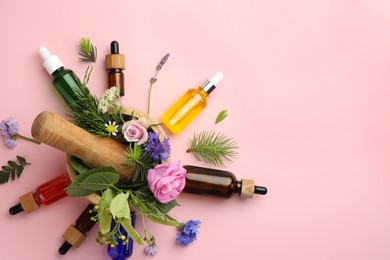 Photo of Aromatherapy. Different essential oils, fir twigs, flowers and green leaves on pink background, flat lay. Space for text