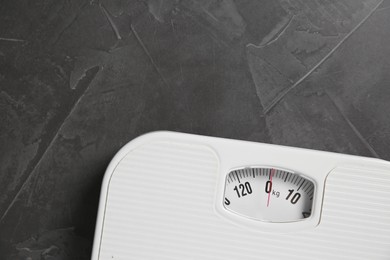 Photo of One bathroom scale on grey textured background, top view. Space for text