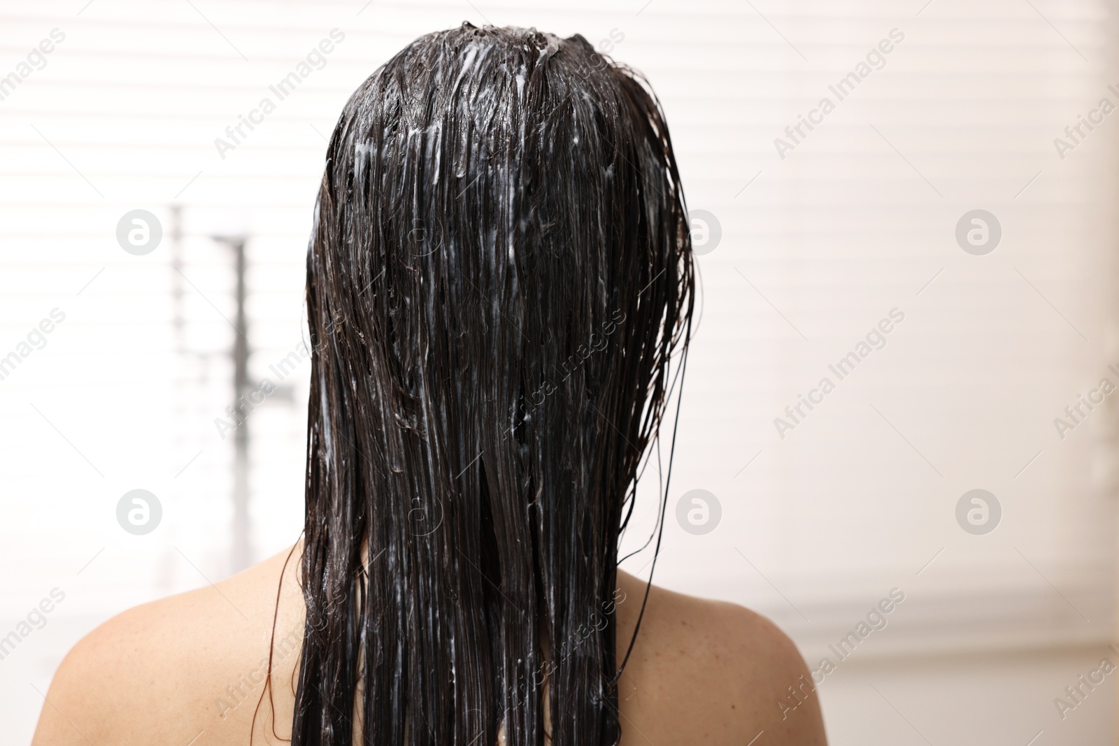 Photo of Woman with applied hair mask in bathroom, back view