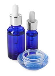 Photo of Bottles of chemical peel and bowl with liquid isolated on white. Peeling procedure