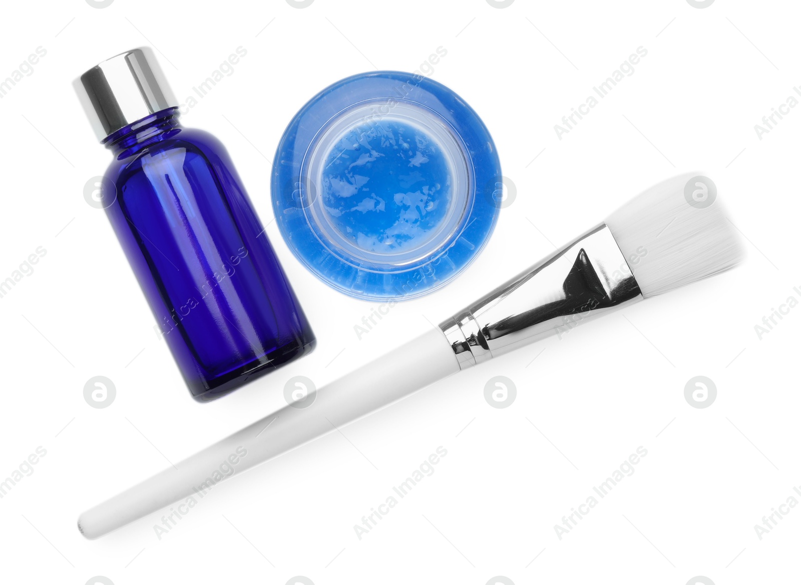 Photo of Bottle of chemical peel, bowl with liquid and brush isolated on white, top view. Peeling procedure