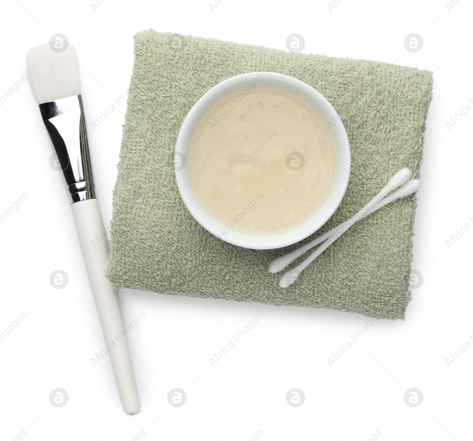 Photo of Bowl of chemical peel, towel, ear sticks and brush isolated on white, top view. Peeling procedure