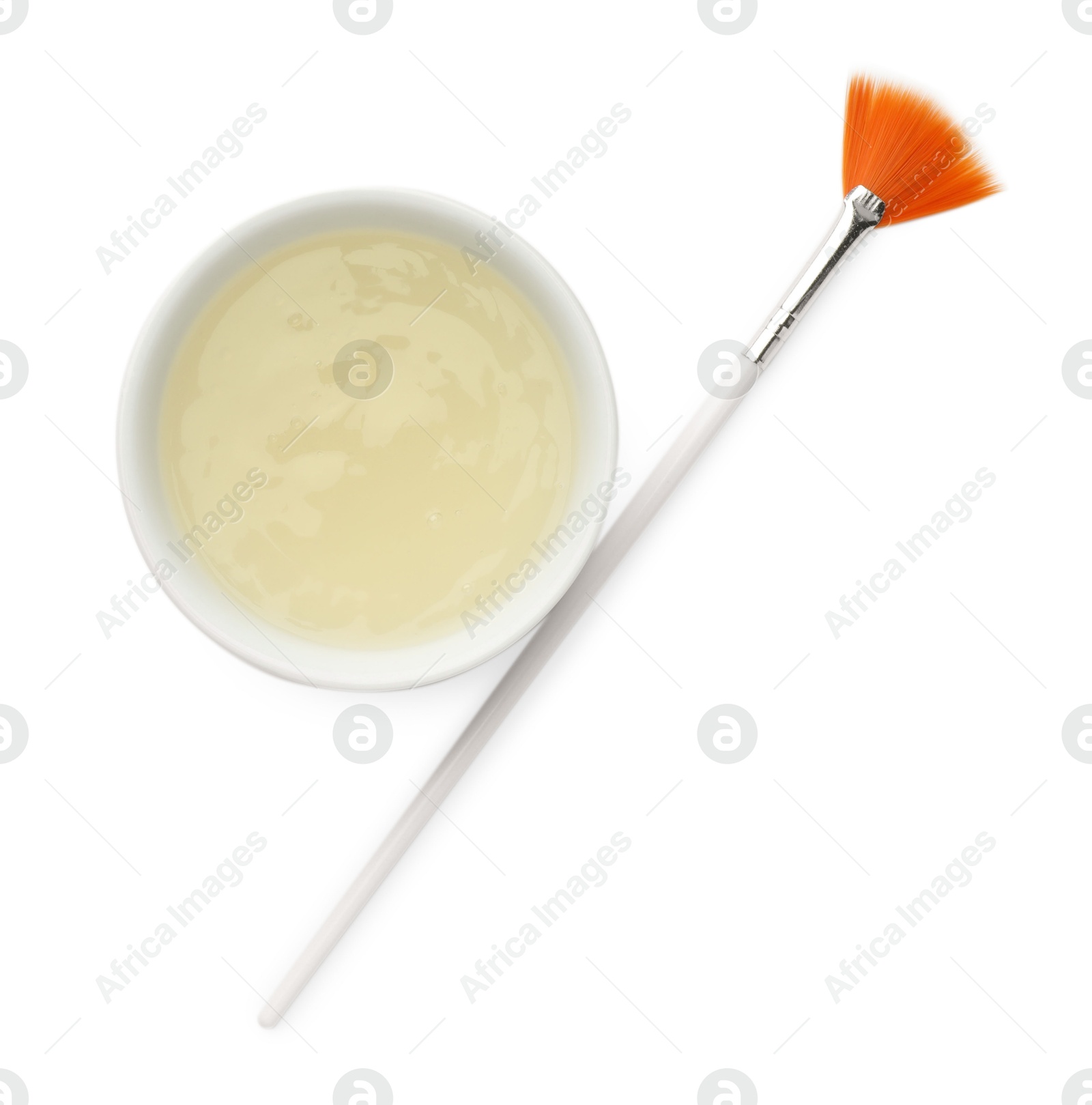 Photo of Bowl of chemical peel and brush isolated on white, top view. Peeling procedure