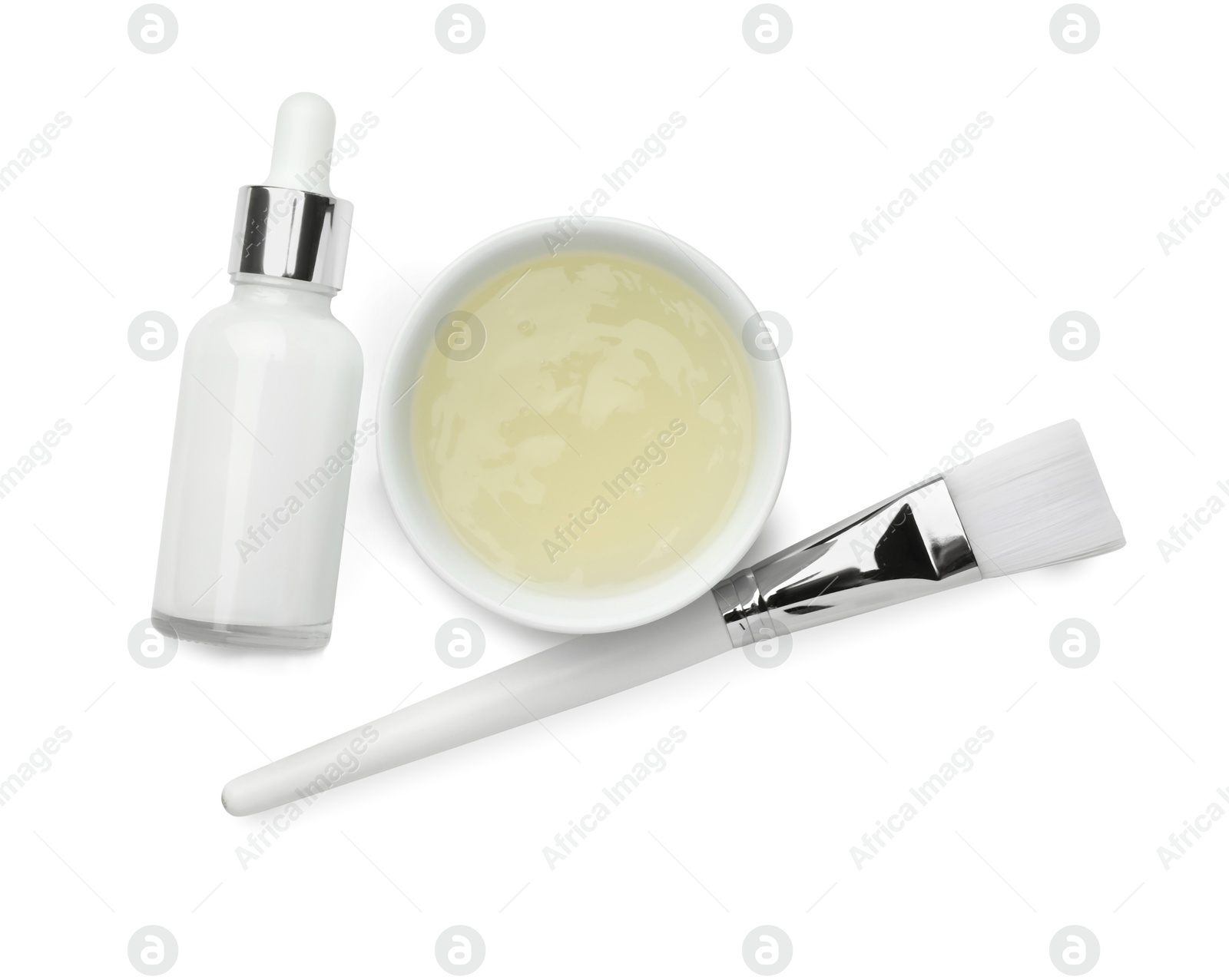 Photo of Bottle of chemical peel, bowl with liquid and brush isolated on white, top view. Peeling procedure