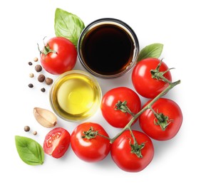 Delicious balsamic vinegar, olive oil, tomatoes and spices isolated on white, top view