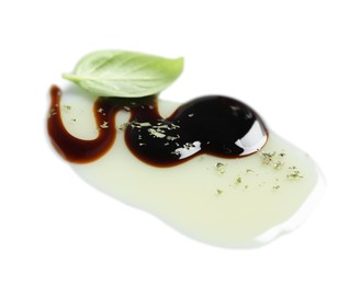 Delicious balsamic vinegar with olive oil, basil and herbs on white background