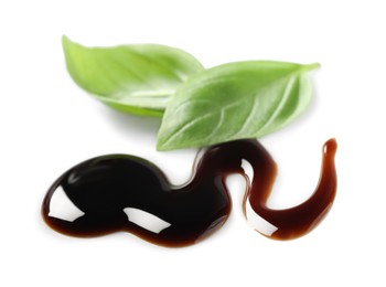 Delicious balsamic vinegar and basil leaves isolated on white