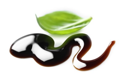 Photo of Delicious balsamic vinegar and basil leaf isolated on white