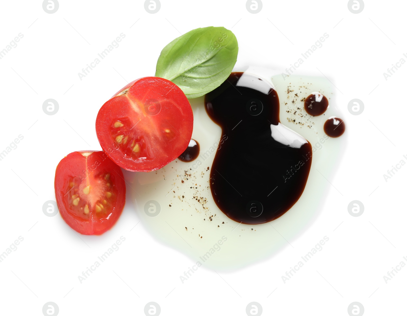 Photo of Delicious balsamic vinegar with olive oil, basil and tomato on white background, top view