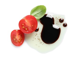 Photo of Delicious balsamic vinegar with olive oil, basil and tomato on white background, top view