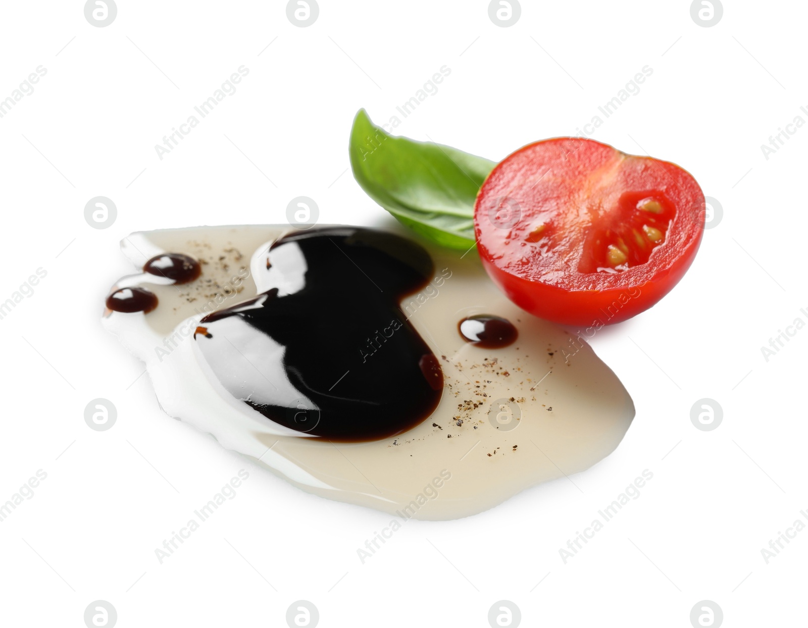 Photo of Delicious balsamic vinegar with olive oil, basil and cut tomato on white background