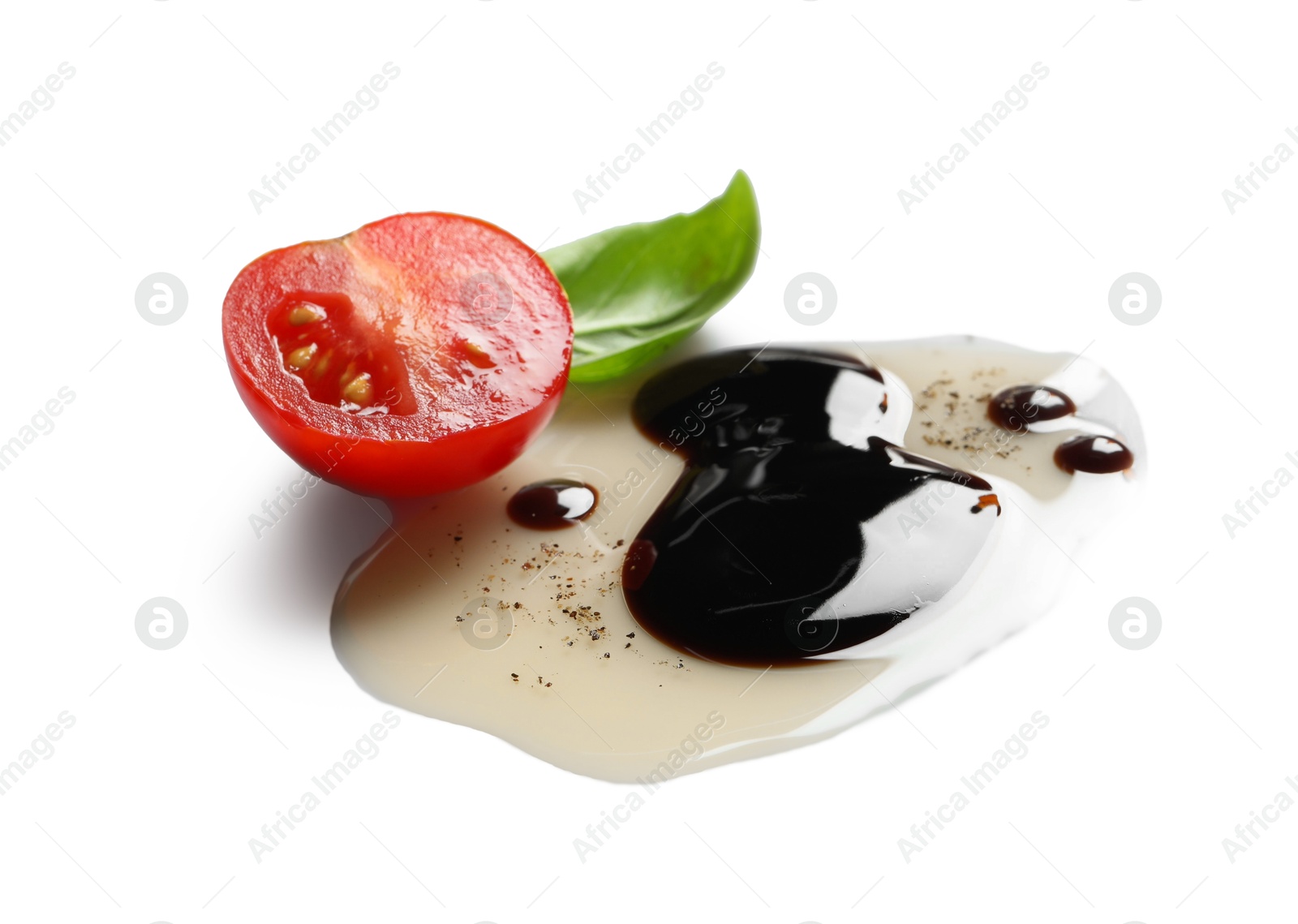 Photo of Delicious balsamic vinegar with olive oil, basil and cut tomato on white background