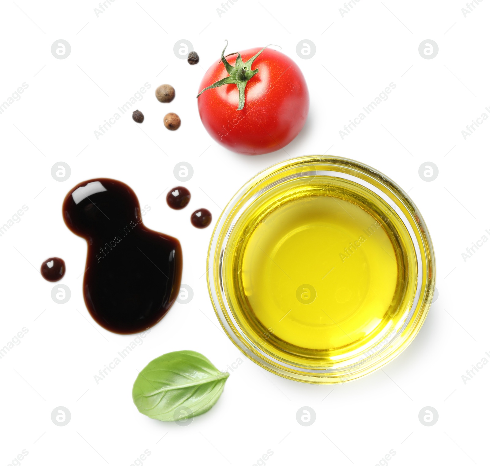 Photo of Delicious balsamic vinegar with olive oil, tomato, basil and peppercorns isolated on white, top view