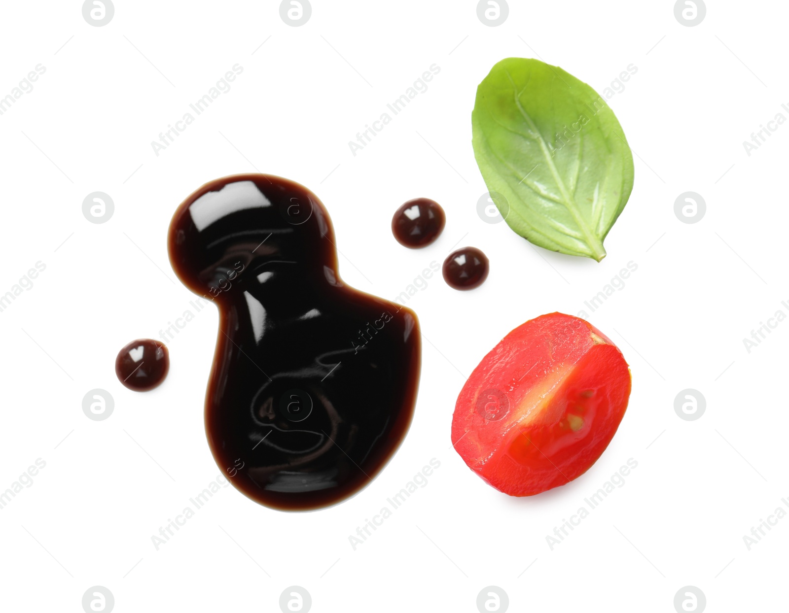 Photo of Delicious balsamic vinegar, cut tomato and basil isolated on white, top view