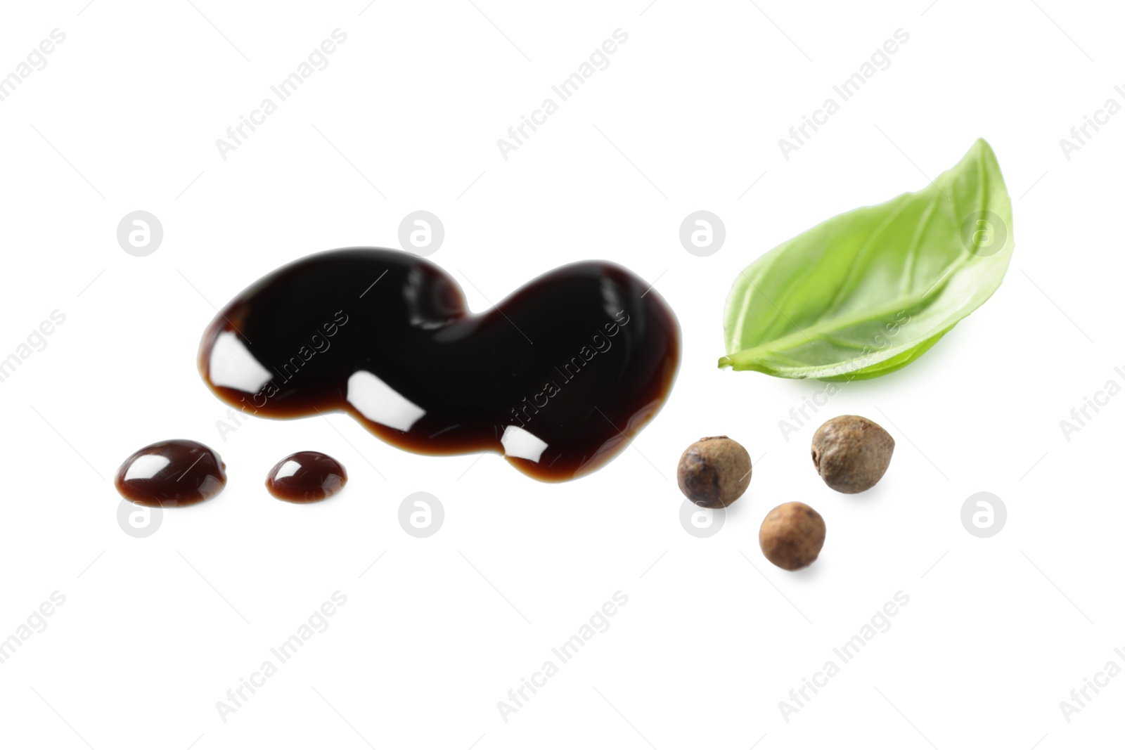 Photo of Delicious balsamic vinegar, basil and peppercorns isolated on white