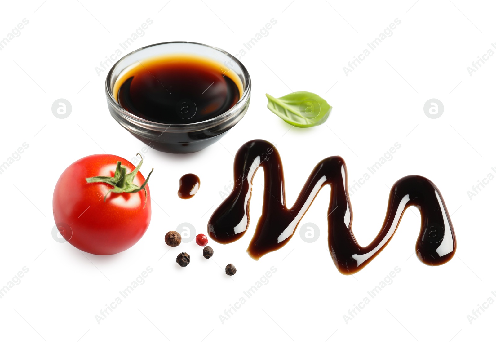 Photo of Delicious balsamic vinegar, tomato, basil and peppercorns isolated on white