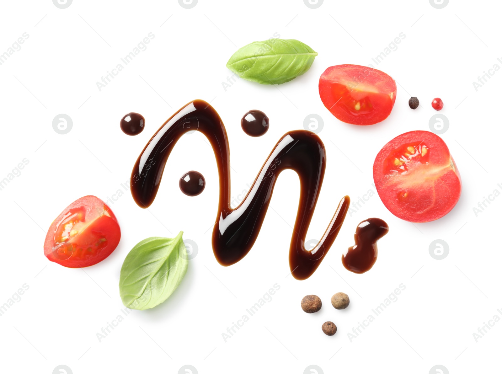 Photo of Delicious balsamic vinegar, cut tomatoes, basil and peppercorns isolated on white, top view