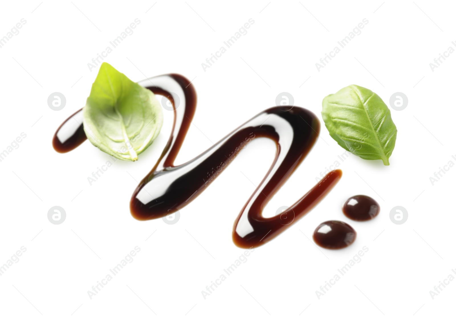 Photo of Delicious balsamic vinegar and basil leaves isolated on white